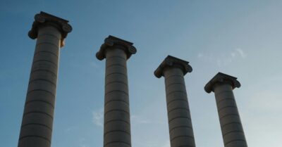 Photo of four pillars standing against a blue sky
