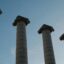Photo of four pillars standing against a blue sky